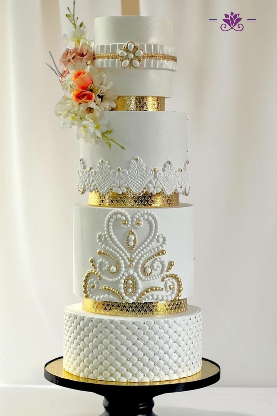 Sophisticated 4-tier white and gold wedding cake