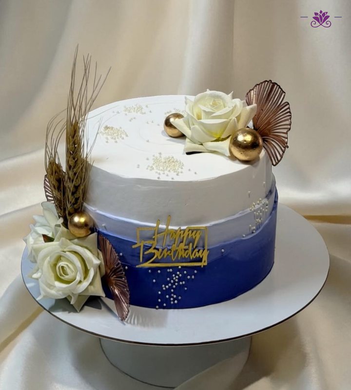 Royal Blue & White Birthday Cake with Floral Design, Gold Accents & Ombre Finish (Eggless Designer Cake)
