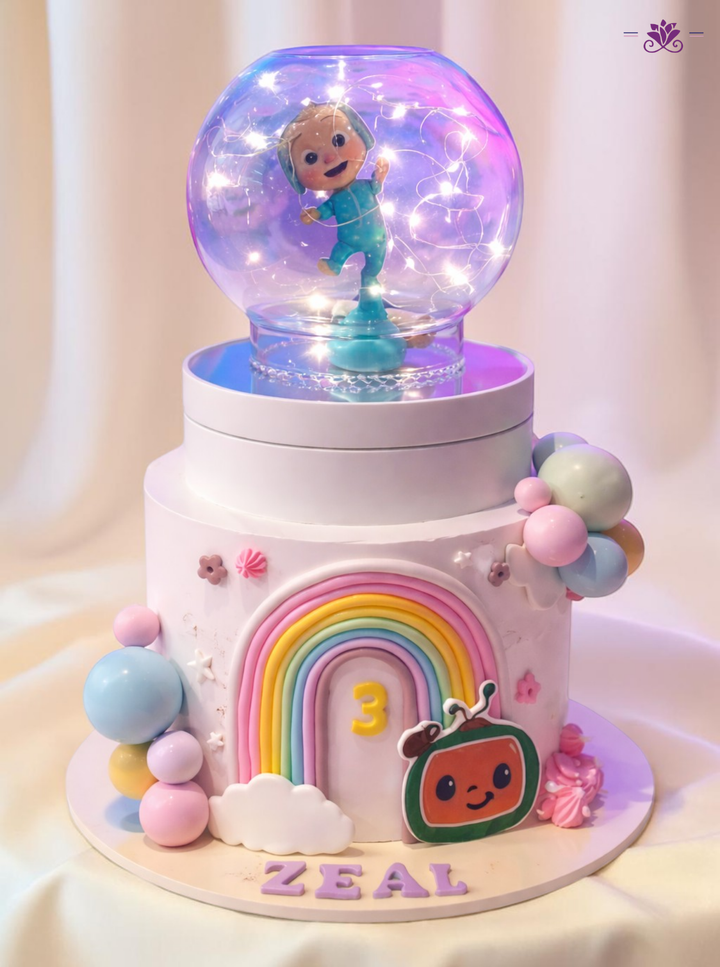 Cocomelon Theme Birthday Cake with LED Globe, Rainbow Design & Cartoon Topper (Eggless Designer Cake)