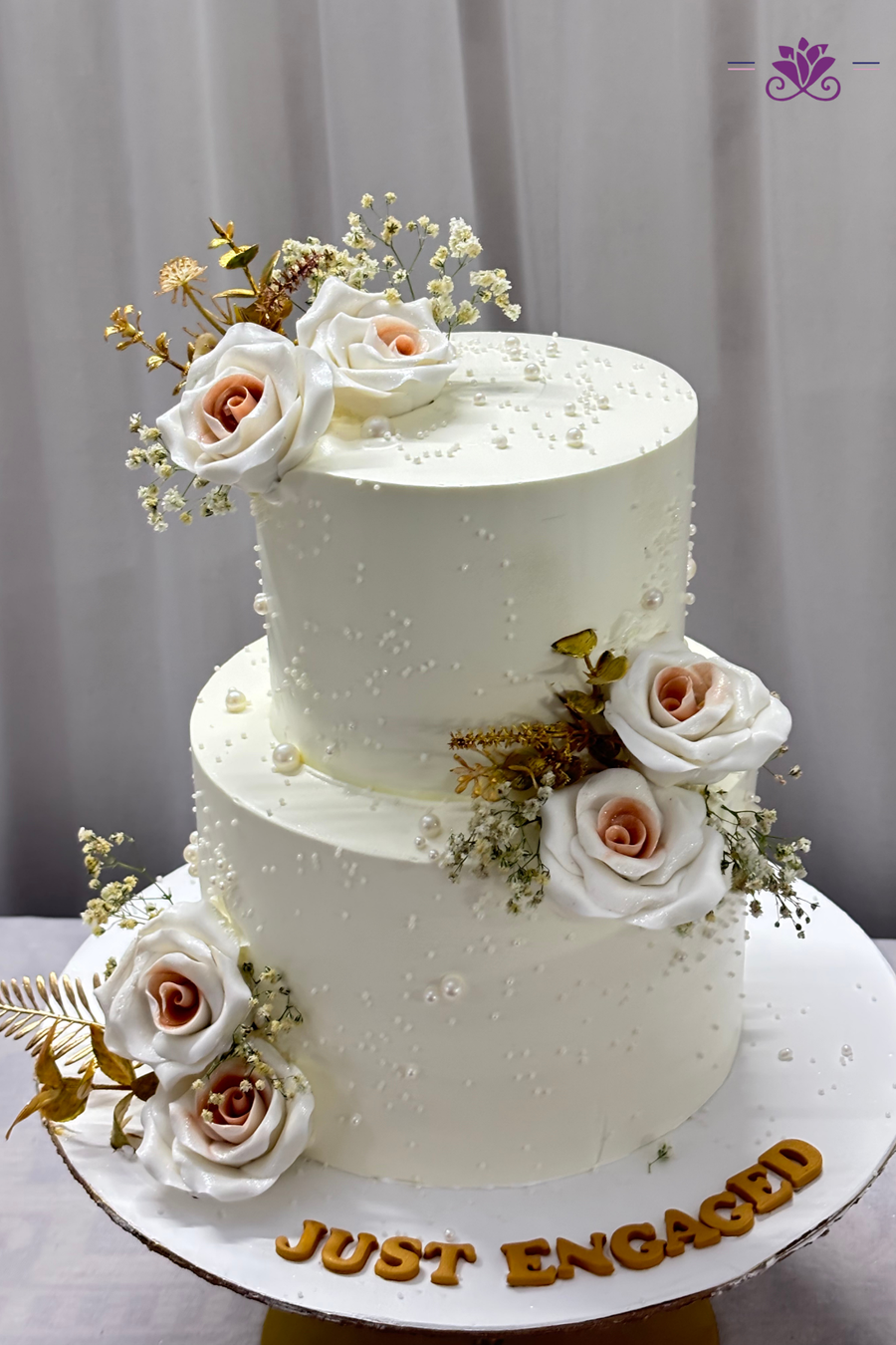 Sophisticated 2-tier white engagement cake