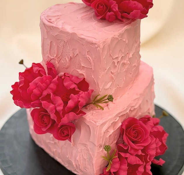Beautiful pink heart-shaped birthday cake