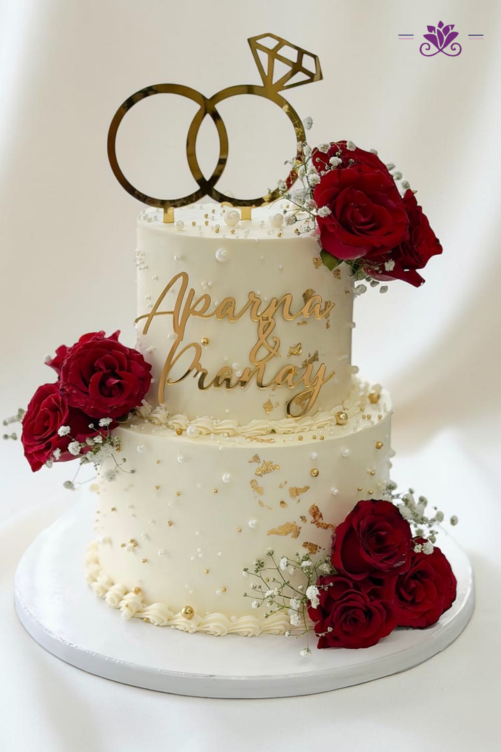 Sophisticated two-tier white and gold anniversary cake