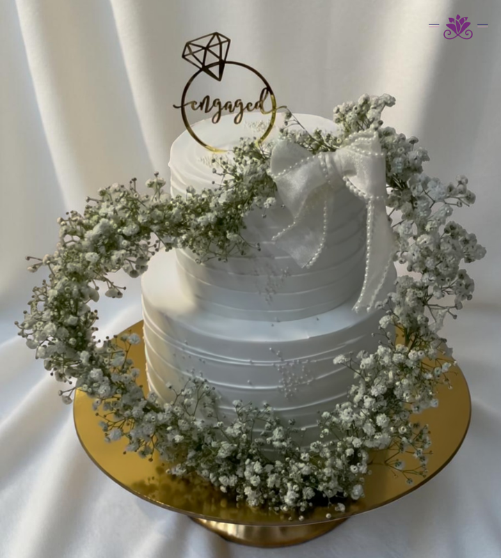 Elegant Engagement Cake with Baby’s Breath Flowers, Pearl Bow & Ring Topper (Eggless Designer Cake)